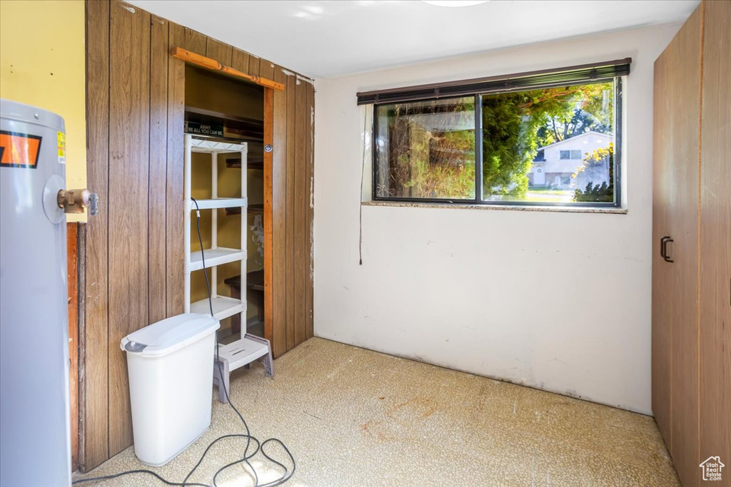 Interior space featuring wooden walls and light carpet