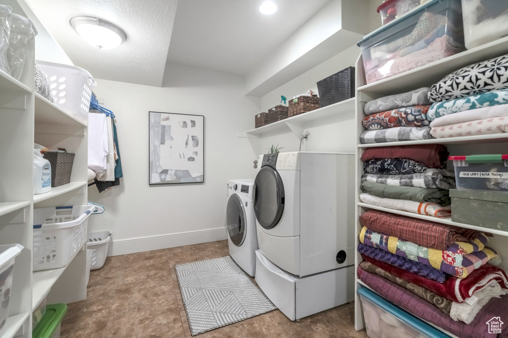 Clothes washing area featuring washer and dryer