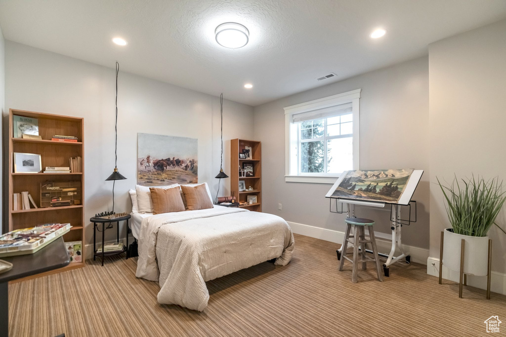 Bedroom featuring light carpet