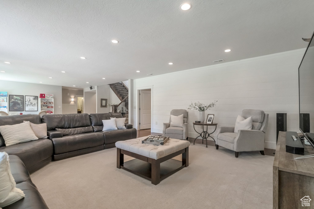 Carpeted living room featuring a textured ceiling