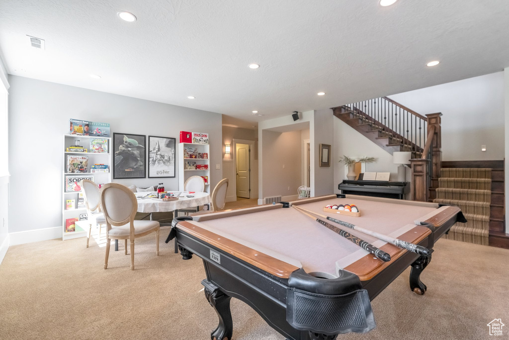 Recreation room featuring light carpet, a textured ceiling, and pool table