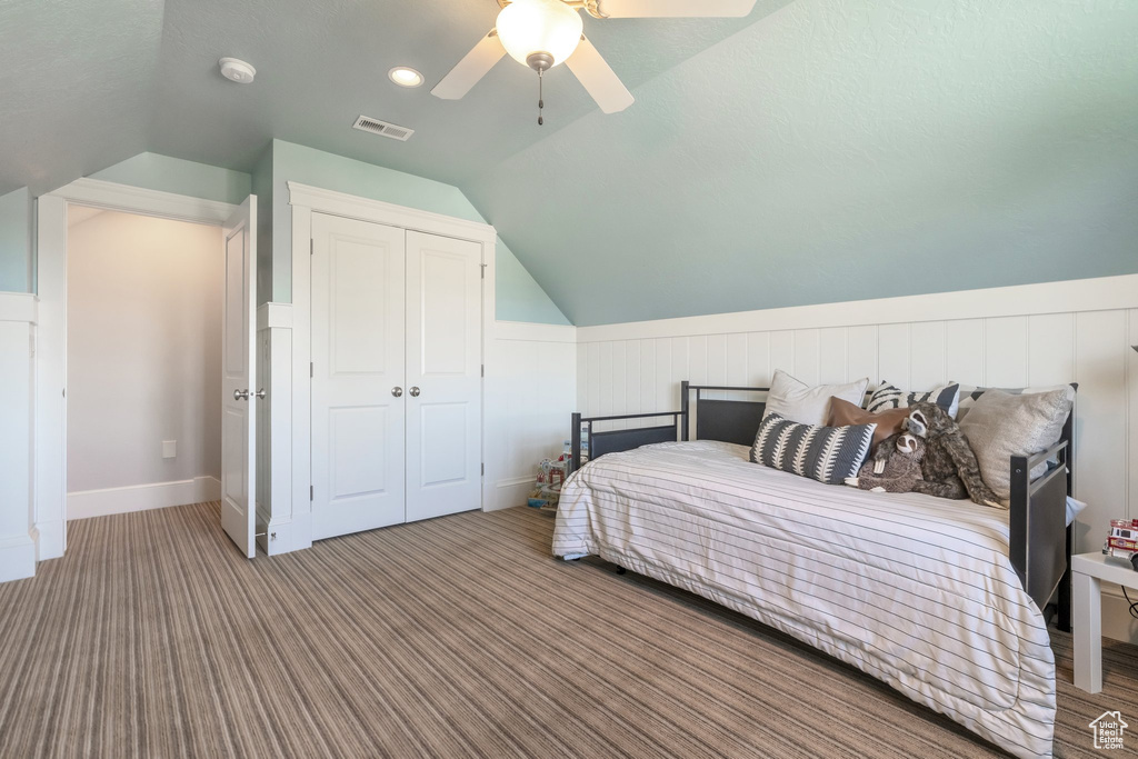 Bedroom featuring ceiling fan, lofted ceiling, hardwood / wood-style floors, and a closet