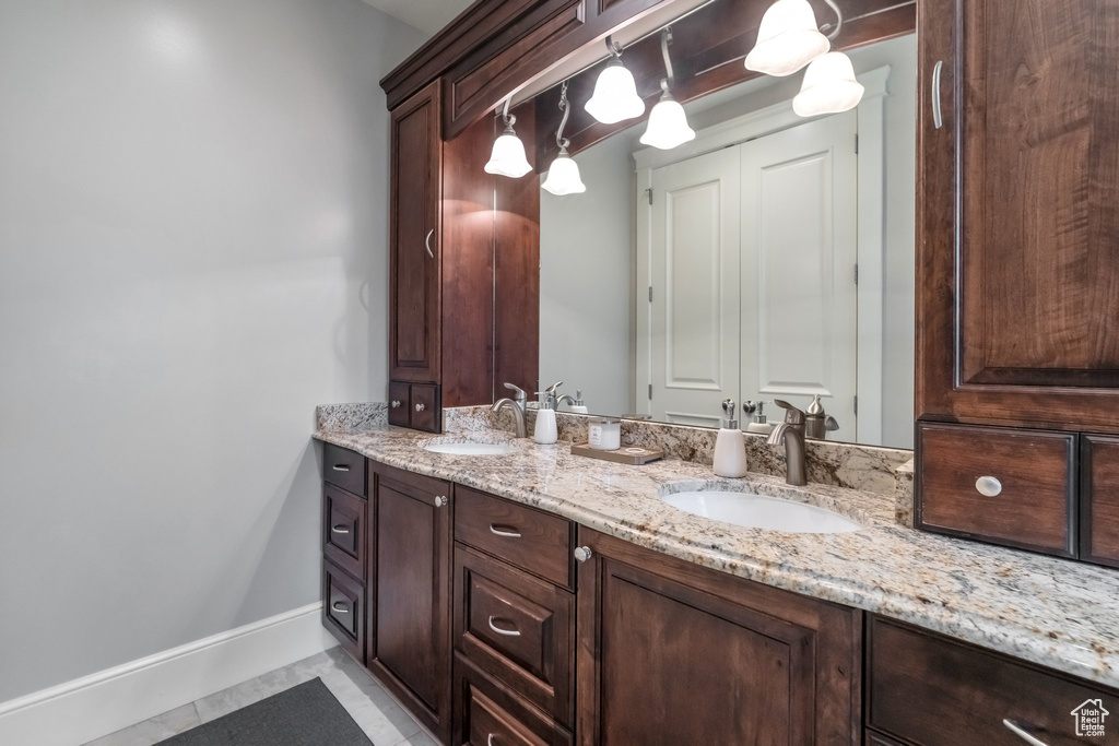 Bathroom featuring tile patterned flooring and vanity