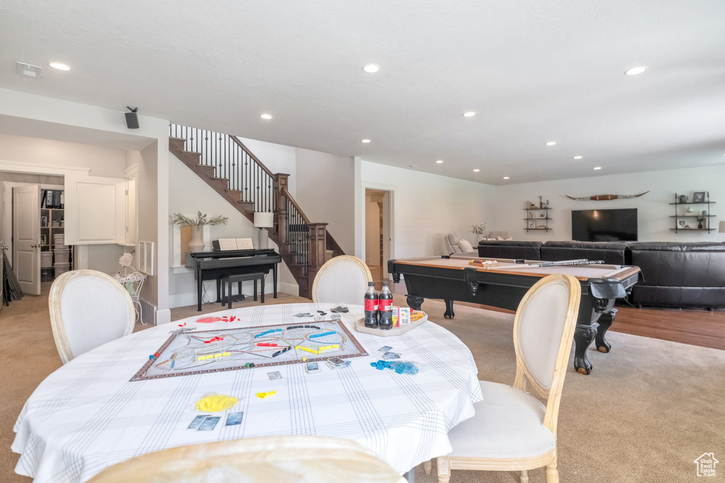 Dining room with light carpet and pool table