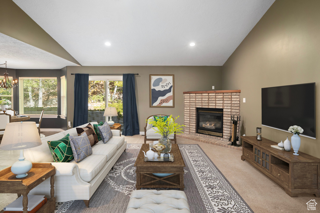 Carpeted living room featuring a brick fireplace, a chandelier, and vaulted ceiling