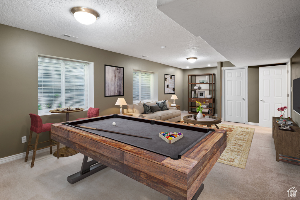 Rec room featuring light carpet, a textured ceiling, and billiards