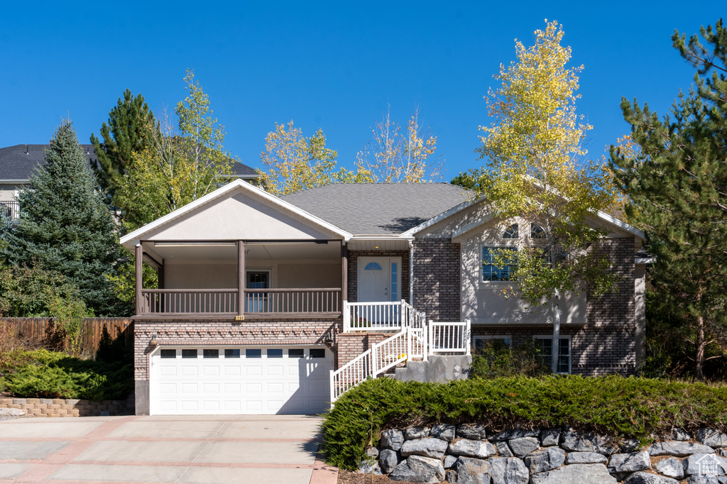 View of front of house featuring covered porch and a garage