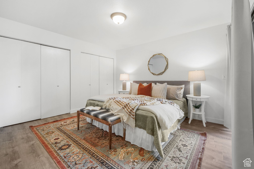 Bedroom featuring two closets and hardwood / wood-style floors