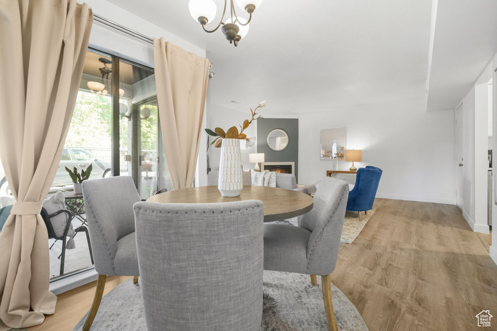 Dining space with an inviting chandelier and light hardwood / wood-style floors