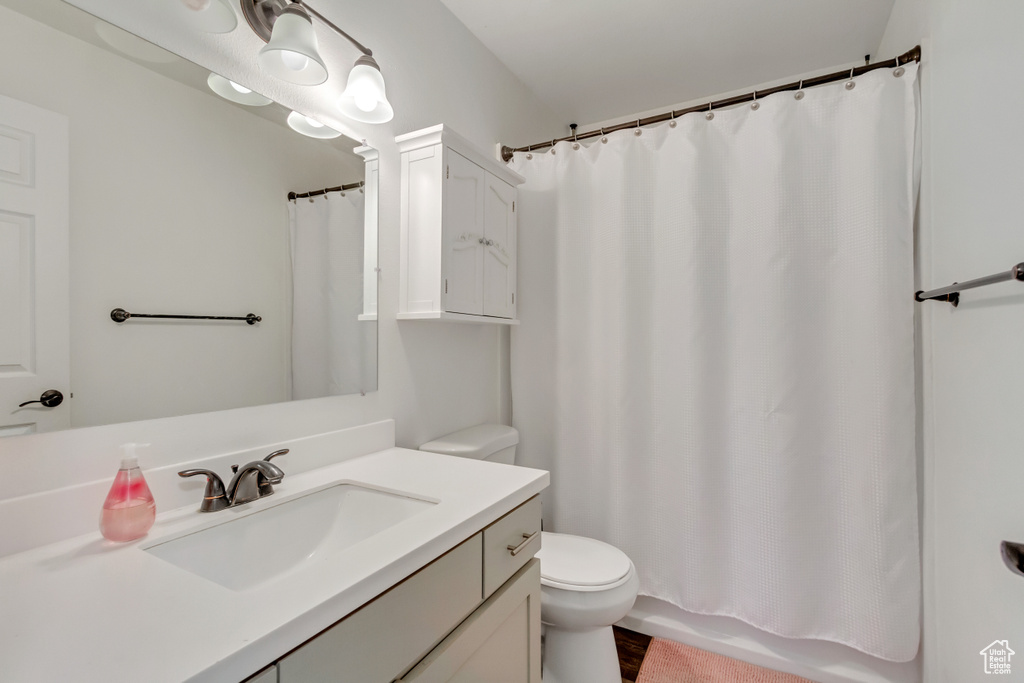 Bathroom with walk in shower, vanity, and toilet