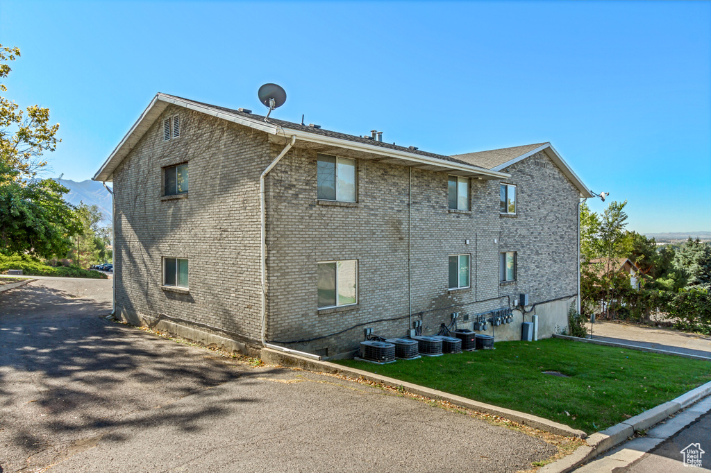 View of property exterior featuring a lawn