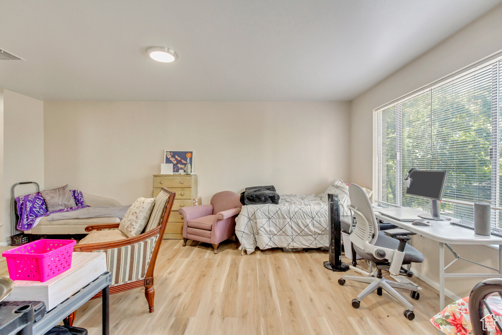 Bedroom with light hardwood / wood-style floors