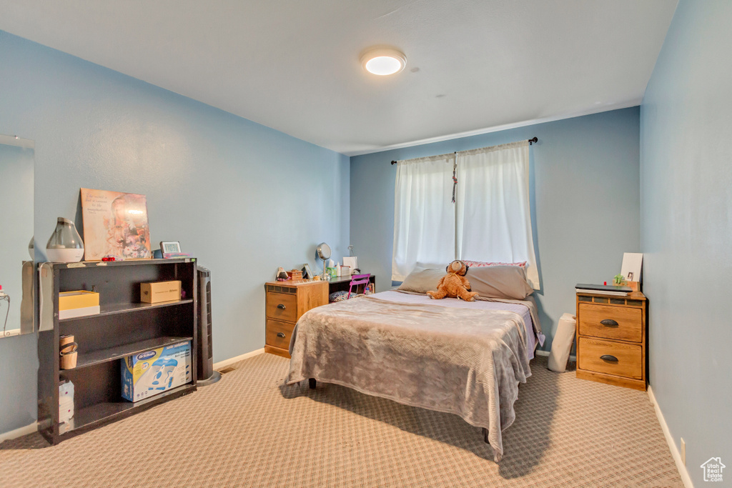 Bedroom featuring light colored carpet