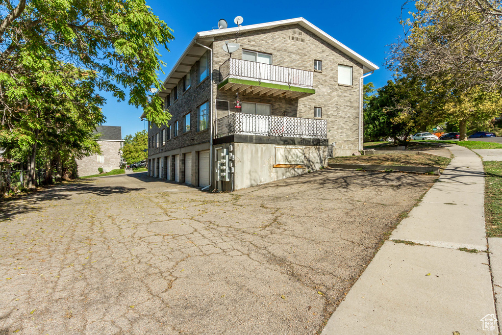 View of home\'s exterior with a balcony and a garage