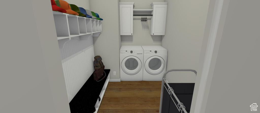 Clothes washing area featuring washer and clothes dryer and dark wood-type flooring