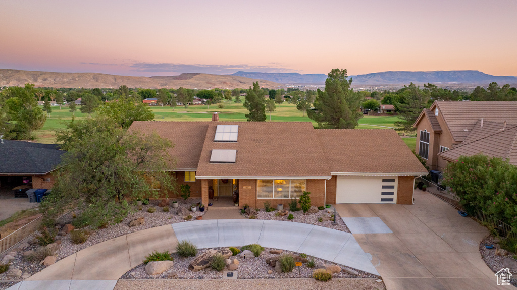 View of front facade featuring a garage and a mountain view