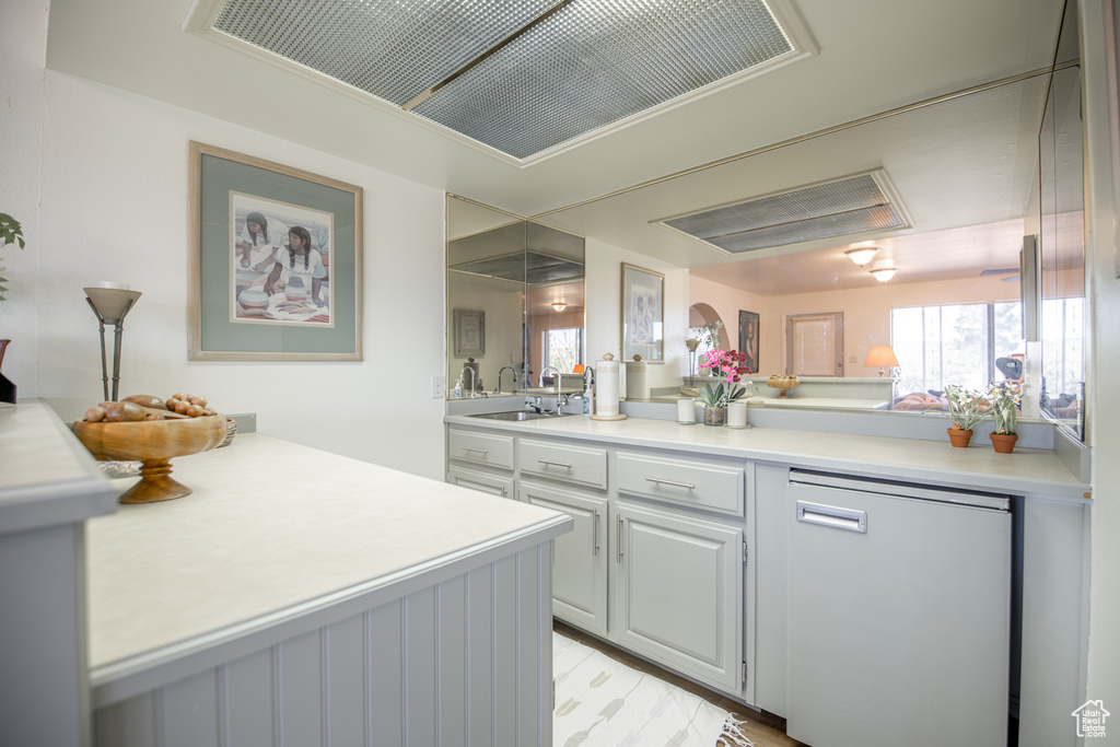 Kitchen with dishwasher, kitchen peninsula, and sink