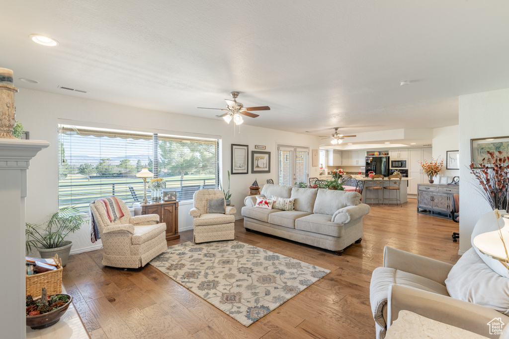 Living room featuring light hardwood / wood-style floors and ceiling fan