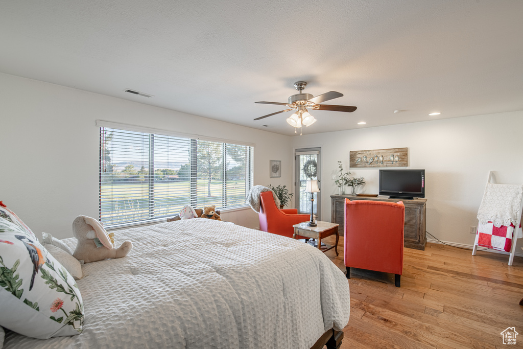 Bedroom featuring light hardwood / wood-style floors and ceiling fan