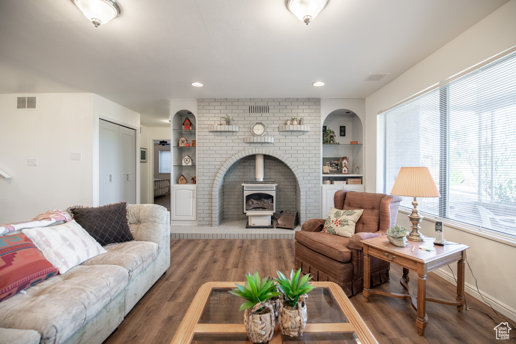 Living room featuring dark wood-type flooring and a fireplace