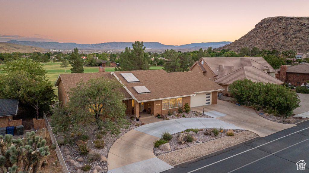 View of front facade with a mountain view and a garage