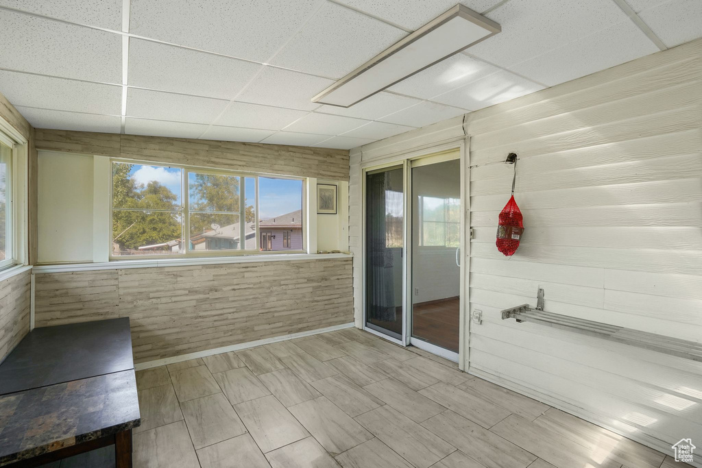 Unfurnished sunroom featuring a paneled ceiling