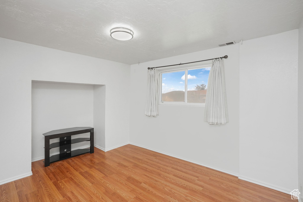 Empty room with light wood-type flooring