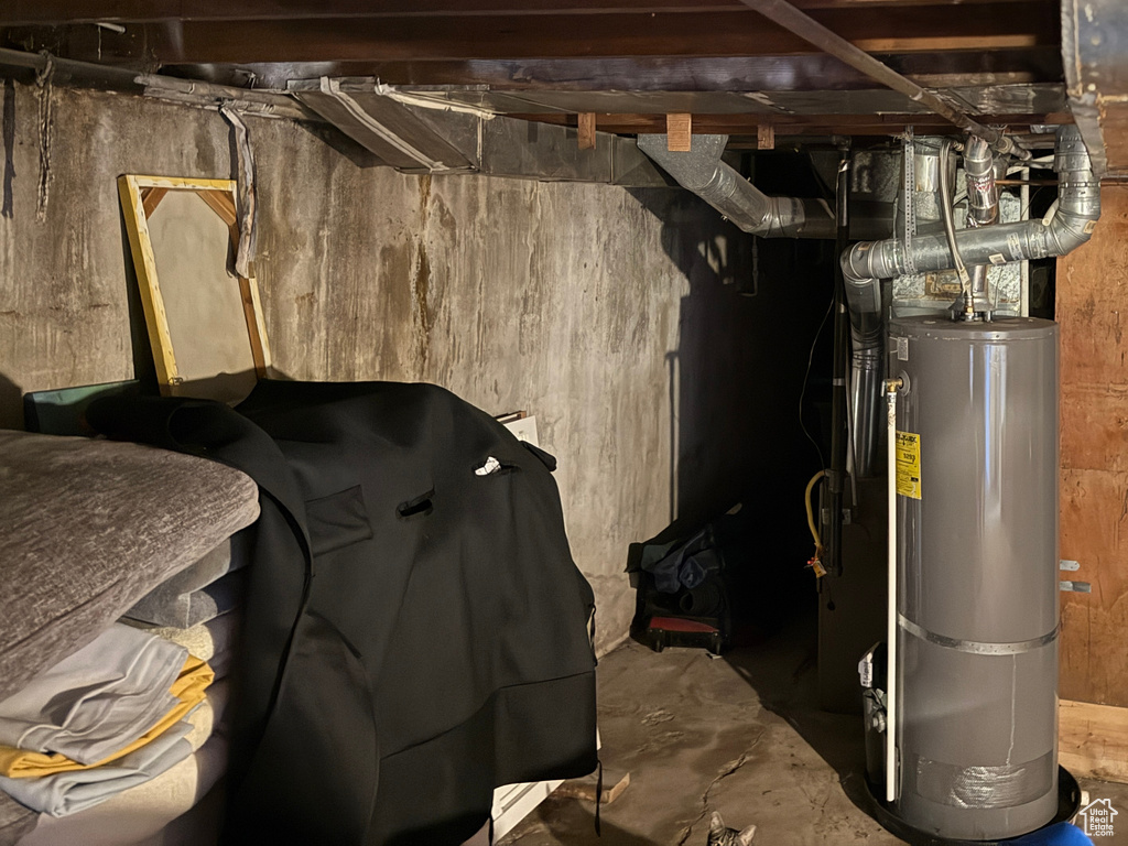 Unfinished basement featuring water heater