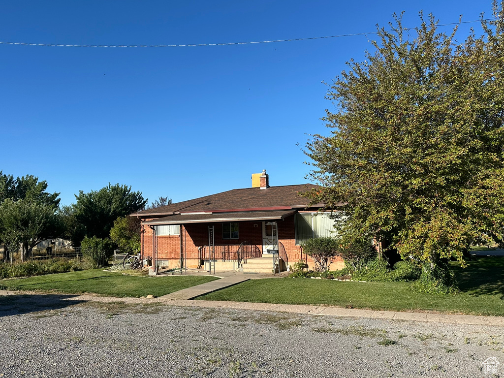 View of front of house featuring a porch and a front lawn