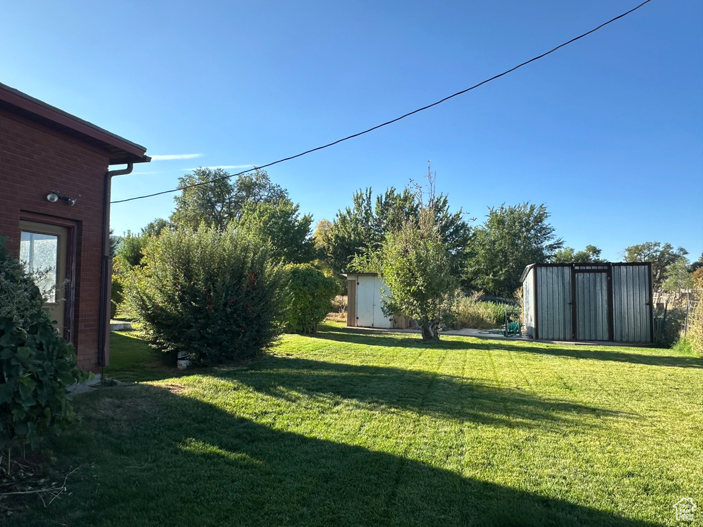 View of yard featuring a storage unit