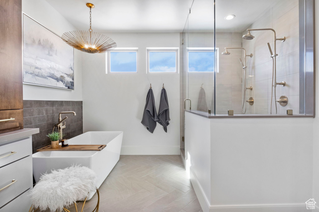 Bathroom with vanity, parquet floors, and separate shower and tub