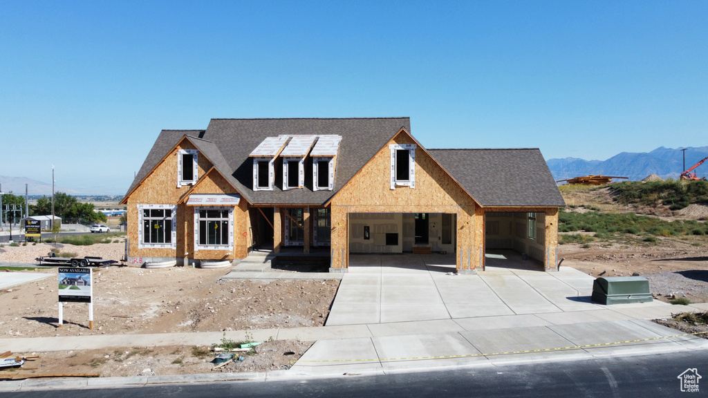 Property in mid-construction featuring a mountain view and a carport