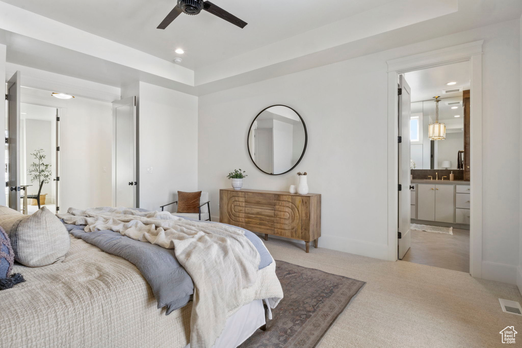 Carpeted bedroom featuring ensuite bath