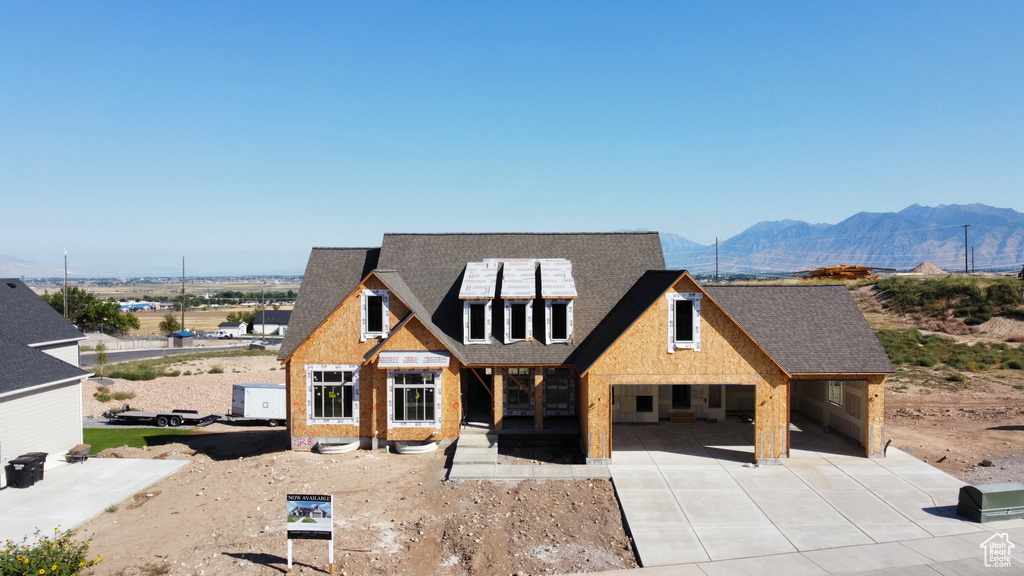 View of front of home featuring a patio and a mountain view