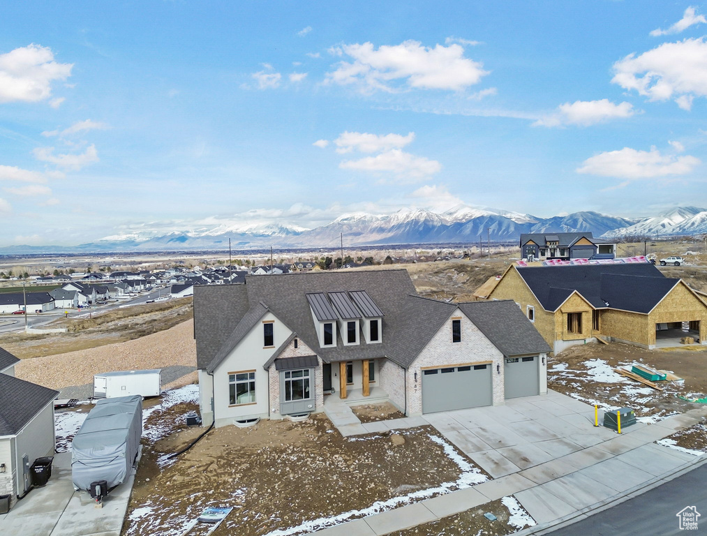 View of front facade featuring a garage and a mountain view