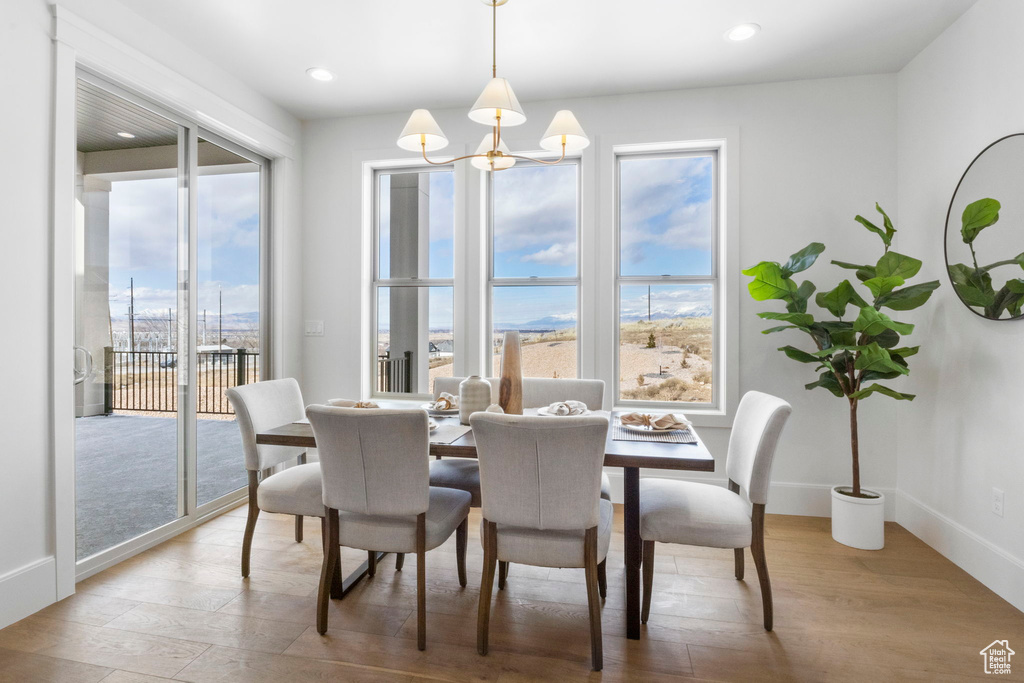 Dining area featuring a chandelier and light hardwood / wood-style floors