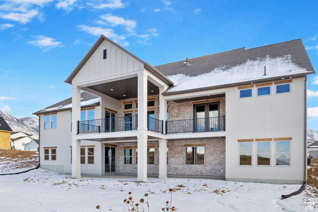 Snow covered house with a balcony