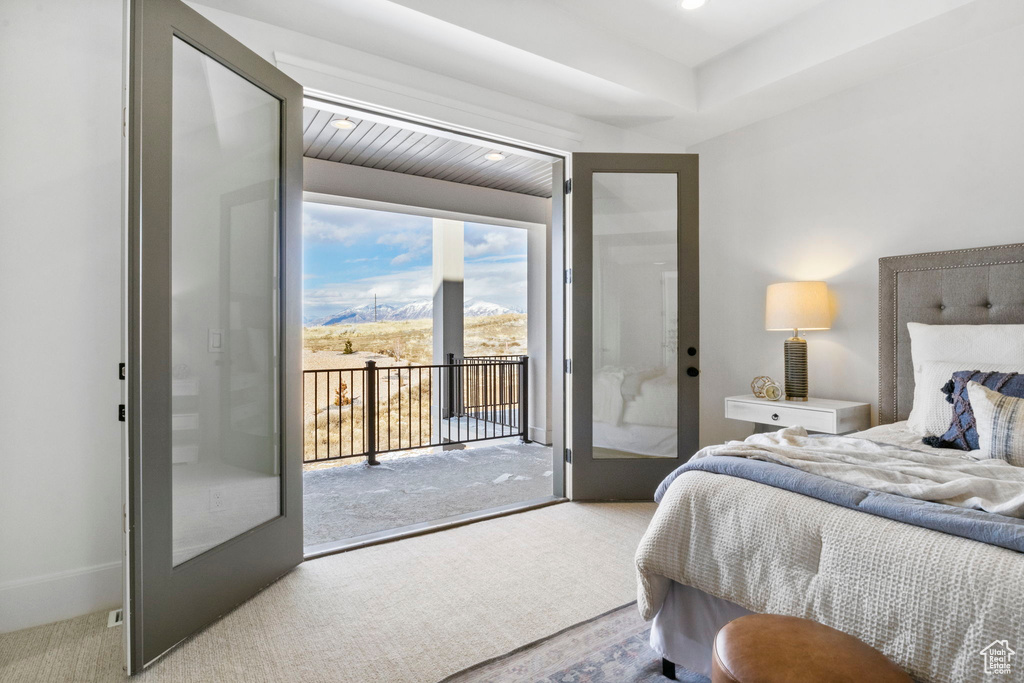 Carpeted bedroom with access to outside and french doors