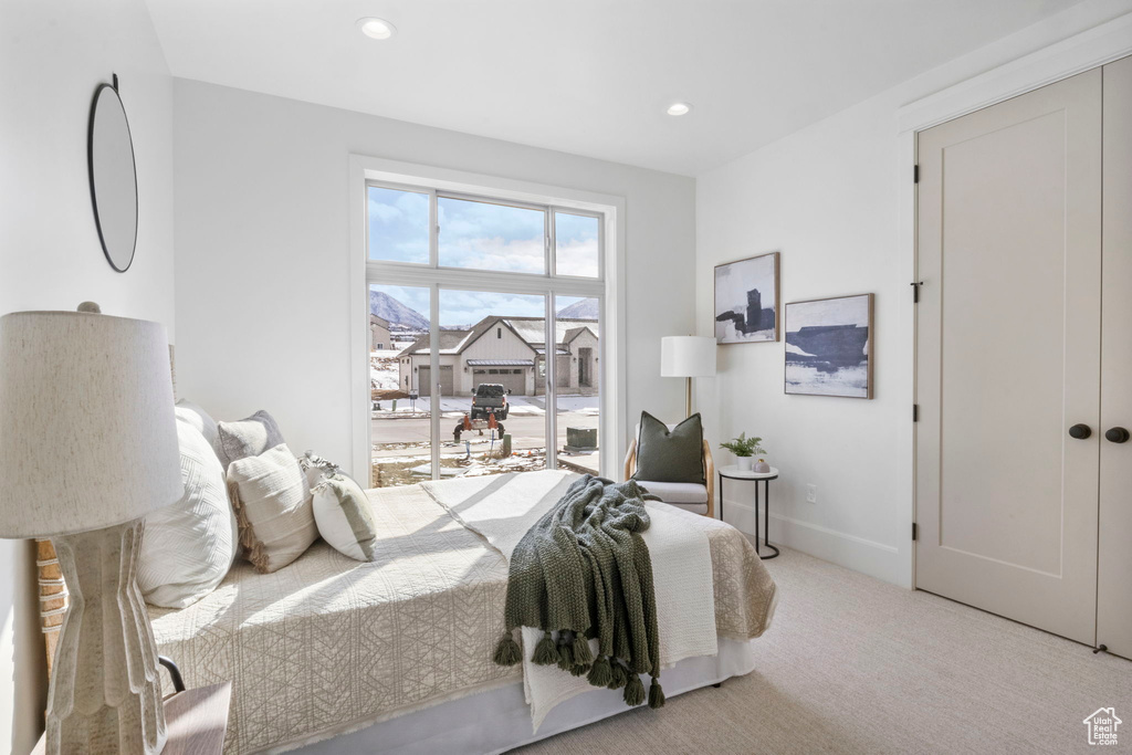 Bedroom with light colored carpet and access to exterior