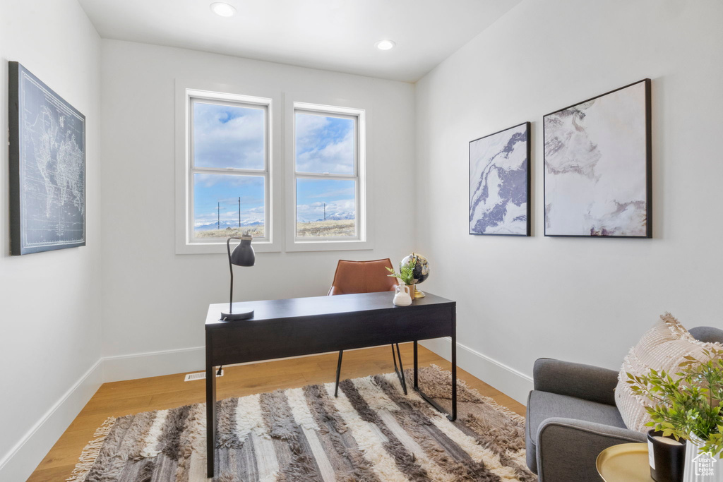 Home office with hardwood / wood-style flooring