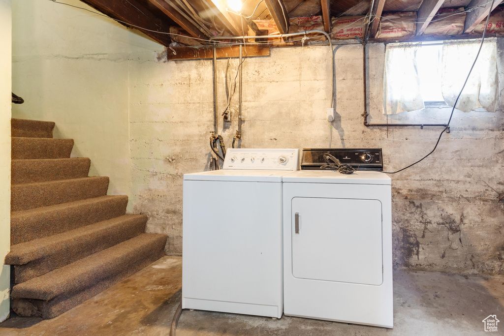 Clothes washing area featuring washer and dryer