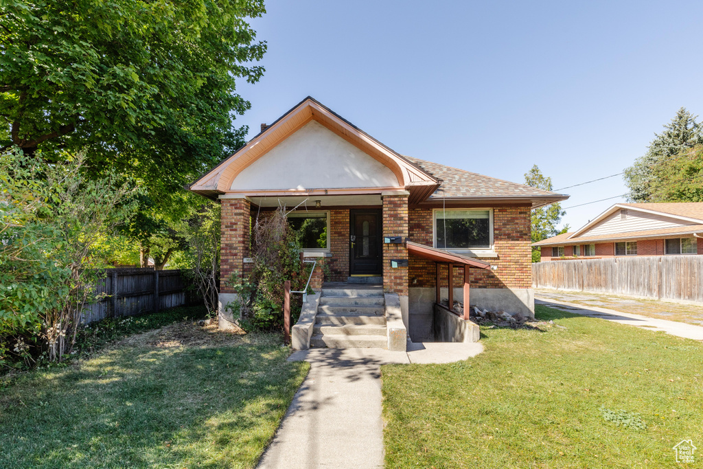 Bungalow-style home featuring a front yard