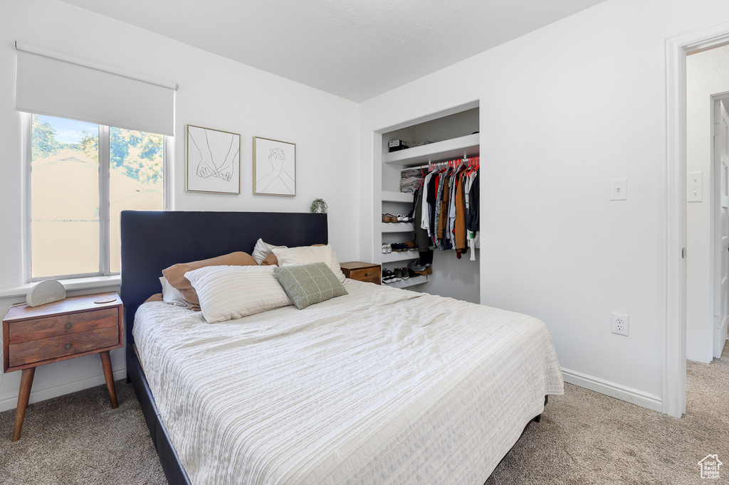 Bedroom featuring carpet and a closet