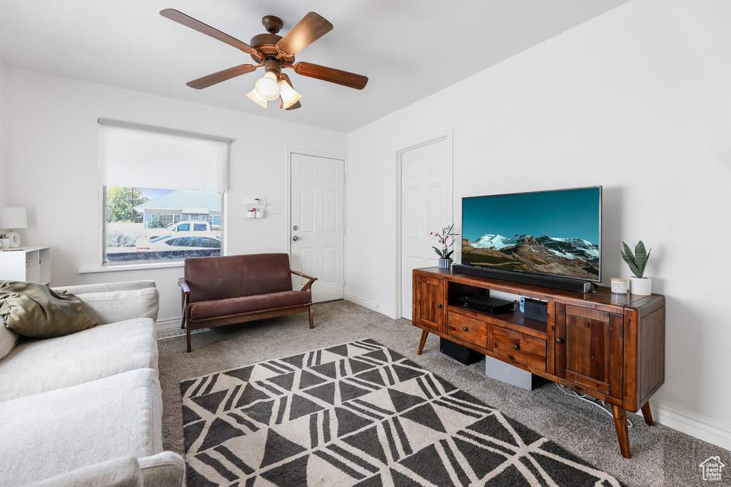 Living room with ceiling fan and carpet floors