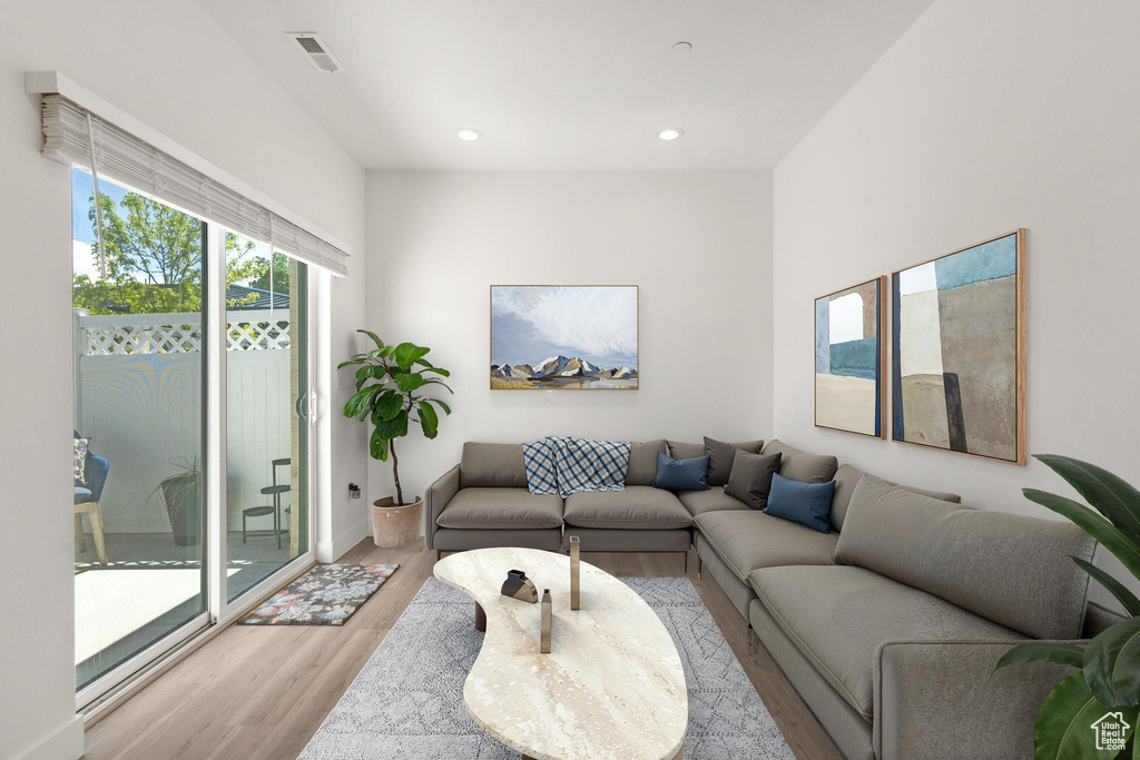 Living room featuring recessed lighting, visible vents, and light wood-type flooring