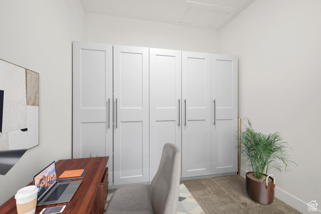 Home office with carpet flooring and attic access