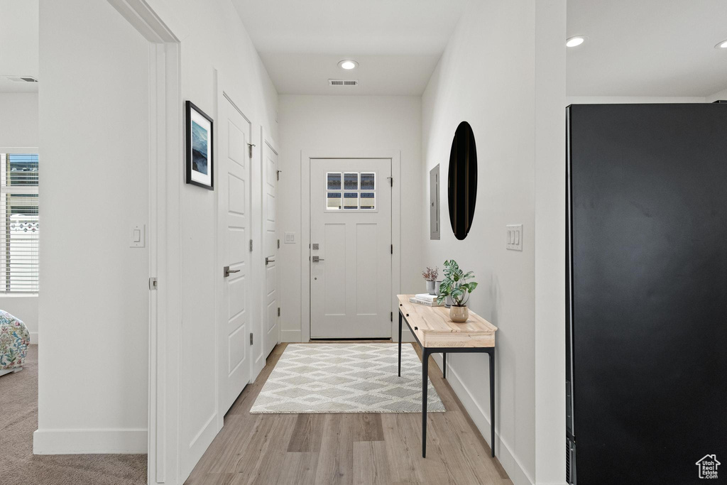 Doorway to outside featuring baseboards, recessed lighting, light wood-style floors, and visible vents