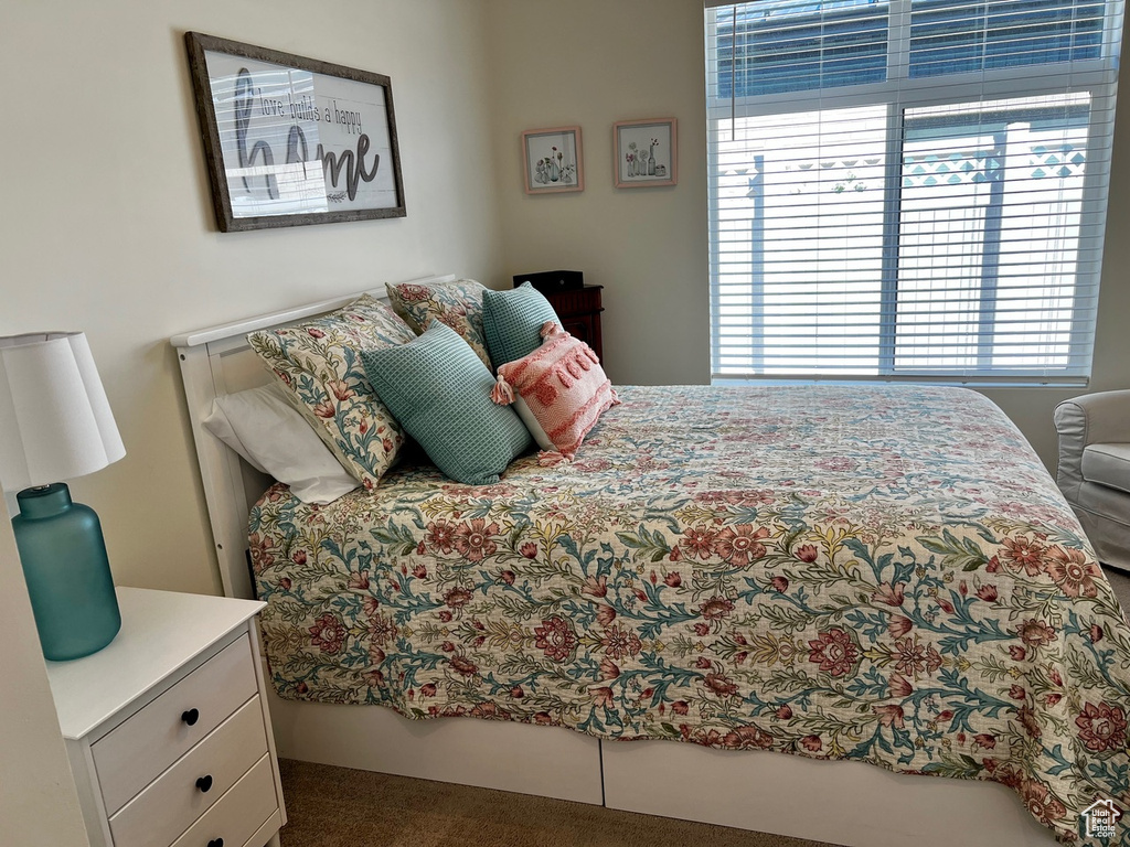 Bedroom featuring dark carpet