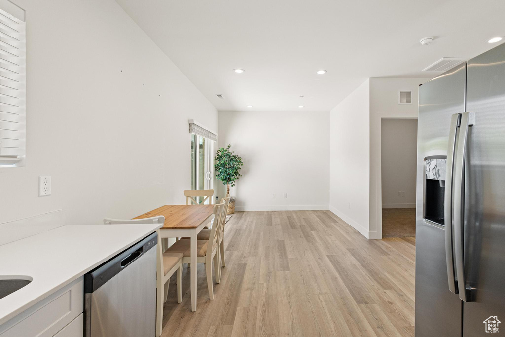 Kitchen with visible vents, light wood-type flooring, light countertops, recessed lighting, and appliances with stainless steel finishes