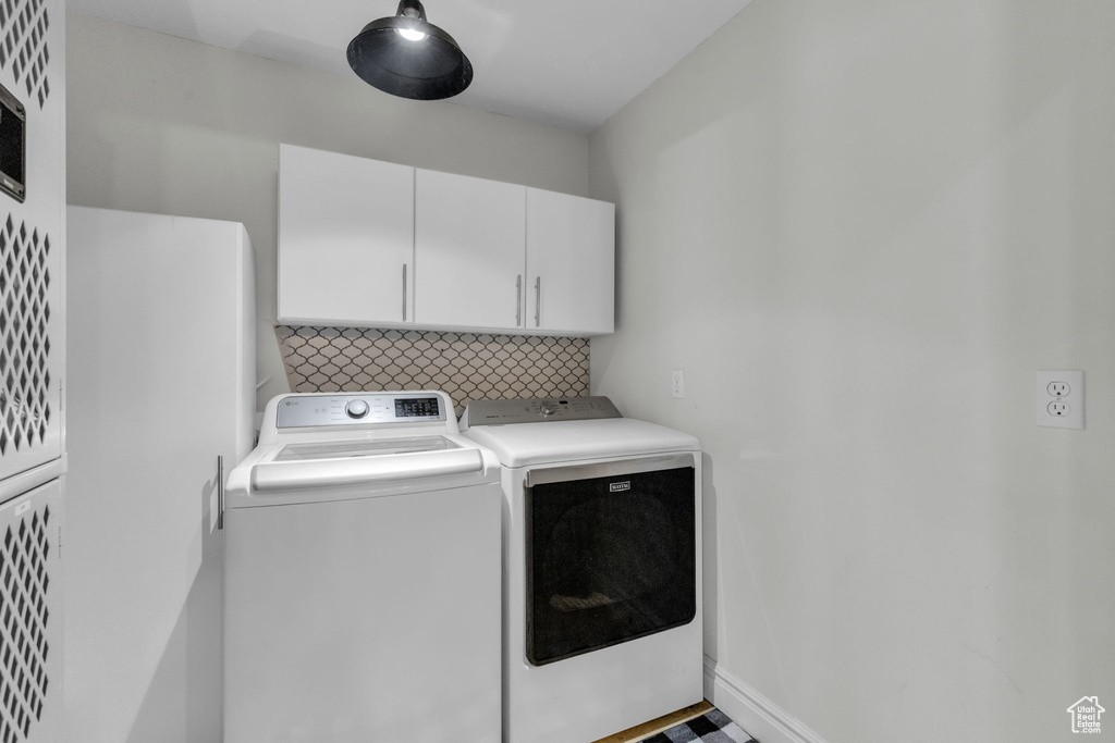 Laundry area with cabinets and separate washer and dryer